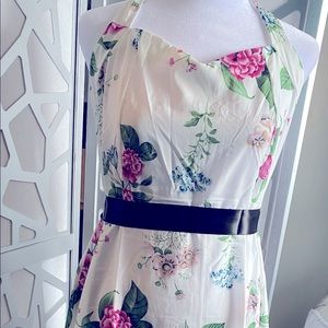 New.  White floral dress, ties behind neck.